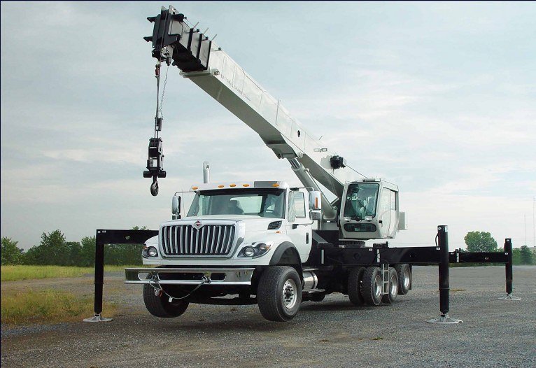 National boom truck crane with outriggers set and the boom raised